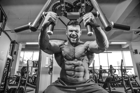 Brutal caucasian handsome fitness men on diet training chest pumping up bodyの写真素材