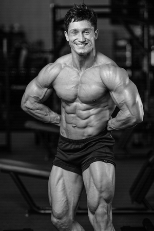 Handsome caucasian sexy fitness model in gym close up abs concept man on diet shirtless training six pack healthcare lifestyle crunchの写真素材