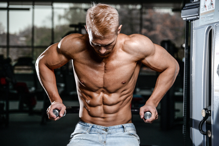 Brutal caucasian handsome fitness men on diet training chest pumping up bodyの写真素材