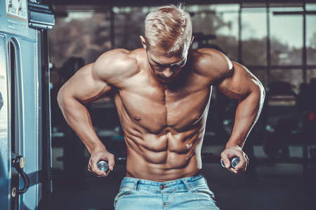 Brutal caucasian handsome fitness men on diet training chest pumping up bodyの写真素材