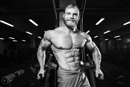Brutal caucasian handsome fitness men on diet training chest pumping up bodyの写真素材