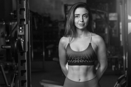 Pretty caucasian sexy fitness female model in gym close up abs concept man on diet shirtless training six pack healthcare lifestyle crunchの写真素材