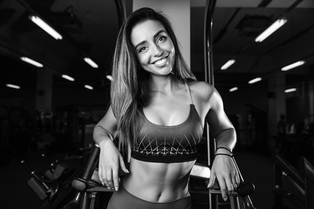 Caucasian sexy pretty fitness girl on diet training chest pumping up beautiful breastの写真素材