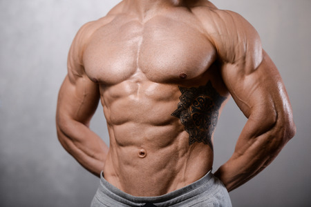 Handsome caucasian sexy fitness model in gym close up abs concept man on diet shirtless training six pack healthcare lifestyle crunchの写真素材
