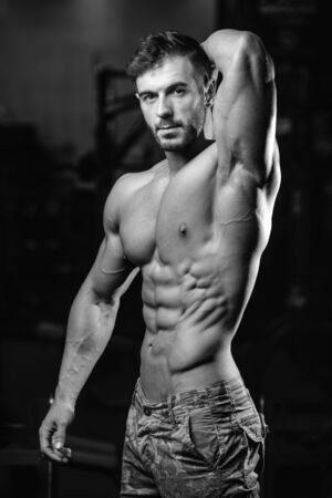 Handsome caucasian sexy fitness model in gym close up abs concept man on diet shirtless training six pack healthcare lifestyle crunchの写真素材