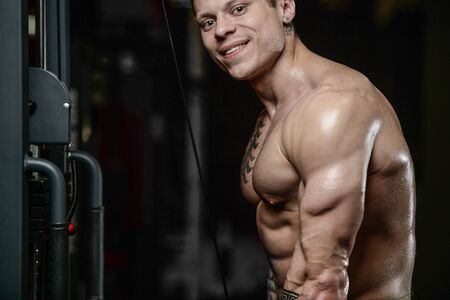 Strong and handsome athletic young tattoo man with muscles . Close-up of a power man on diet abs and biceps fitness and bodybuilding conceptのeditorial素材