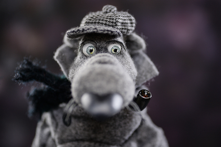Woolen clay statuette doll animal woolen doll gray wolf coat cap scarf detective smoking pipe beauty handmade handcrafted toy craft vintage decor doll gift texture conceptの写真素材
