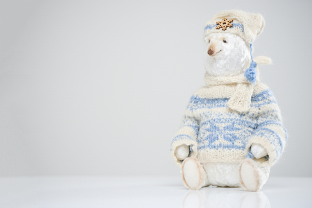 Woolen polar teddy snow bear knitted sweater hat scarf toy beauty handmade handcrafted background craft vintage white blue cute decor doll gift texture conceptの写真素材