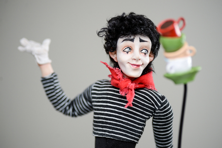 Wooden paper mache clay statuette man brunette white pale makeup young smiling cheer smile cute stripes scarf cups beauty handmade handcrafted toy craft vintage decor doll gift texture conceptの写真素材