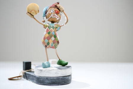 Wooden crying sad clown skull jester clay porcelain paper hat bells costume beauty handmade handcrafted toy craft vintage decor doll gift texture conceptの写真素材