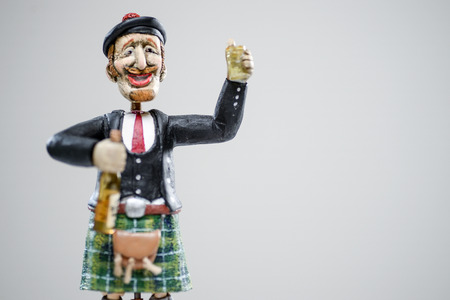 Porcelain paper mache clay statuette man Scottish British smile redhead red cute kilt whisky scotch folk costume beauty handmade handcrafted toy craft vintage decor doll gift texture conceptの写真素材