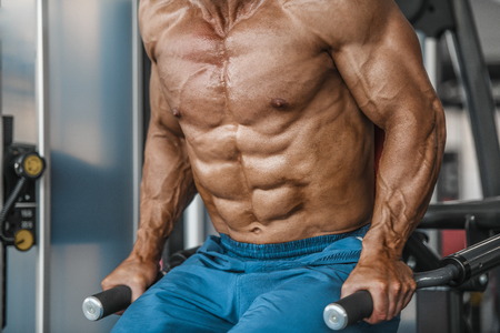 Brutal strong bodybuilder athletic aged man pumping up muscles workout bodybuilding concept...