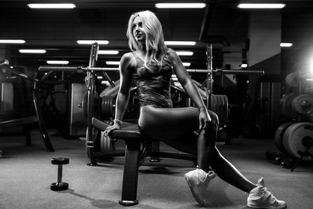 active beautiful Caucasian athletic fit sexy young blonde woman on diet posing showing well rounded butt ass glutes tight buttocks and legs fitness exercise training and bodybuilding erotic conceptの写真素材