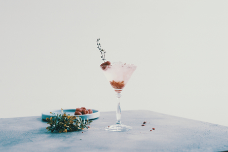 martini glass on a white background with an raspberriesの写真素材
