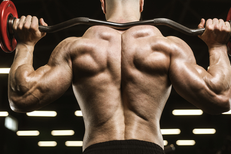 Handsome strong athletic men pumping up muscles workout barbell squat bodybuilding concept background - muscular bodybuilder men doing exercises in gym naked torsoの写真素材