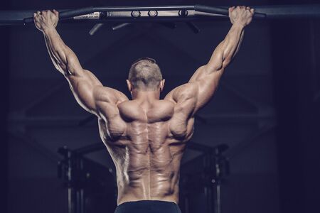 Brutal strong athletic men pumping up muscles workout bodybuilding concept background - muscular...