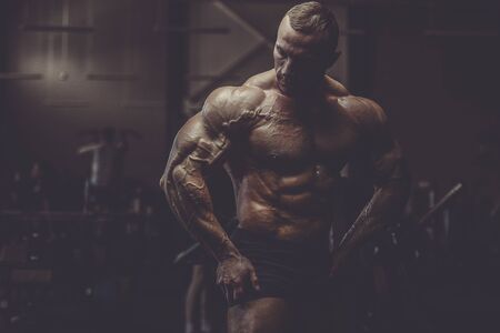 Brutal strong athletic men pumping up muscles workout bodybuilding concept background - muscular...