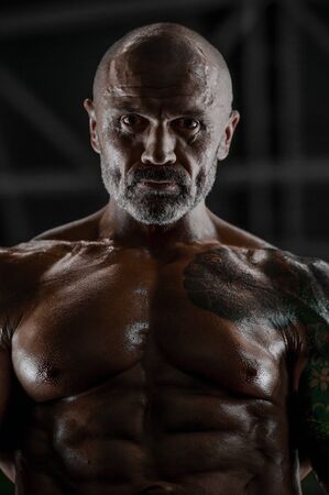 Brutal strong athletic men pumping up muscles workout bodybuilding concept background - muscular bodybuilder handsome men doing exercises in gym naked torsoの写真素材
