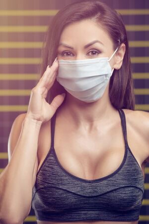 Fitness woman with coronavirus disease COVID-19 infection medical illustration muscles workout. Pretty caucasian fitness girl and bodybuilding concept gym abs, arms, back, chest exercisesの写真素材