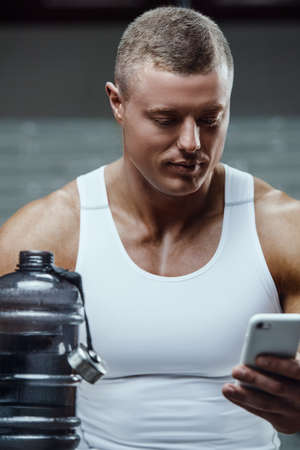 Caucasian power athletic man in fitness training pumping up muscles. Strong bodybuilder with six...