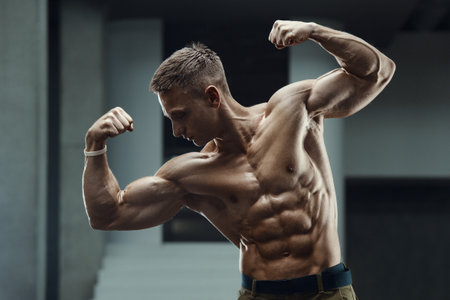 Close up portrait of a handsome fitness man in white shirt in gym. Muscles workout fitness and bodybuilding concept backgroundの写真素材