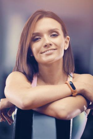 Portrait of young brown-haired woman outdoor at sport playground. Caucasian fitness girl during workout. Sport and health care conceptの写真素材