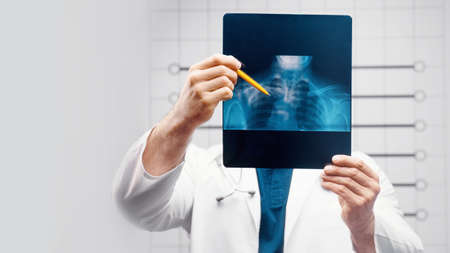 doctor examines the x-ray and mri in the officeの写真素材