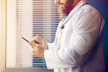 Doctor examines information and writes a prescription online with modern technologyの写真素材