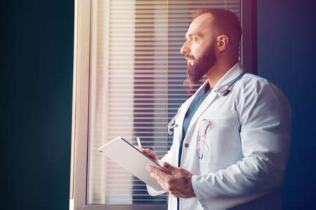 Doctor examines information and writes a prescription online with modern technology. Health care conceptの写真素材