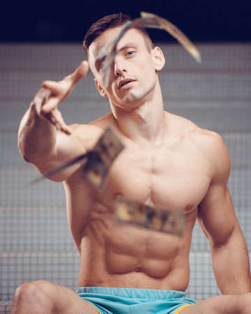 Athlete gymnast in the gym in training with gymnastic rings. Sport and gymnastics conceptの写真素材