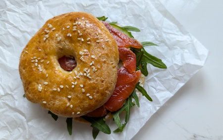 Bagels with curd cheese, fish, and rucola.
