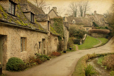 Bibury Traditional Cotswold cottages in England, UK  Photo in retro style  Paper texture 