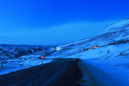 Winding road at dusk in winter, Northeast of Iceland. The Ring Road (Route 1) of Iceland, near  Egilsstadir.の写真素材
