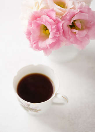 Still life with  cup of coffee  and flowers (Eustoma).  Selective focus. Shallow depth of field.の写真素材