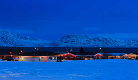 Typical Icelandic houses with Christmas decorations at the twilight near Akureyri, North Iceland.の写真素材