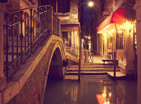 Narrow canal in Venice at night, Italy.  Ponte dei Ferai . Toned imageの写真素材