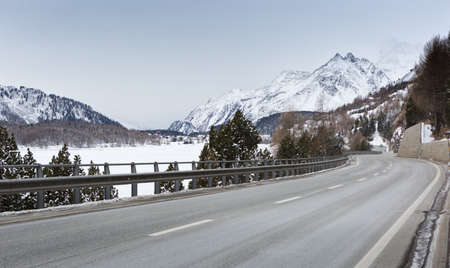 Mountain road in an overcast winter day (Swiss alps). Val Bregaglia; Switzerlandの写真素材