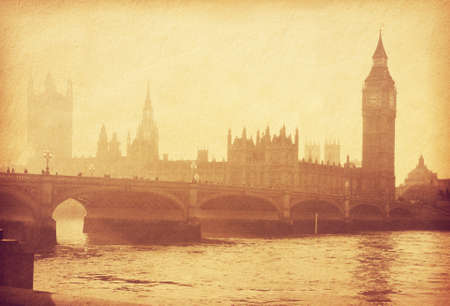 Buildings of Parliament with Big Ben tower in London, UK. Photo in retro style. Added paper texture. Toned imageの写真素材