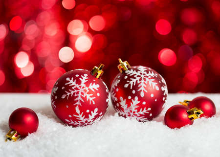 Christmas Baubles on red background with sparkles .の写真素材