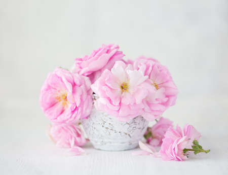 Bouquet of  pale pink roses in clay vase on light grey background. Tea rosesの写真素材