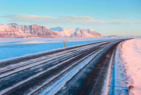 The Ring Road (Route 1) on a sunny winter day along  the snow-capped mountains ( between Hof and Jokulsarlon). South of Icelandの写真素材