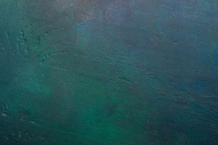Dark green-blue painted wooden background.