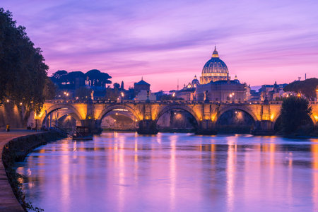 Picturesque view from the Tiber on Ponte Sant'Angelo and St. Peter's Basilica in the twilight,  Rome, Italy.のeditorial素材