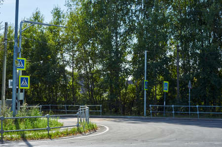 Car passage in the city with trees on the backgroundの写真素材