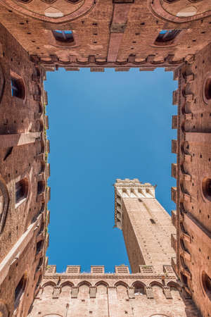 Vertical stamp of Siena from inside the Palazzo Comunale and the Torre del Mangiaのeditorial素材