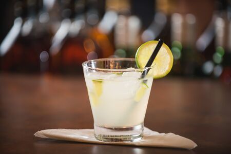 Lemon caipirinha, decorated with cherry on a wooden tableの写真素材