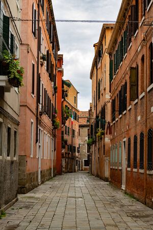 empty alley in the city of Venice, Italy. The empty Venice streets as a resulf of Coronavirus Italian nationwide lockdown, Venice Italyの写真素材