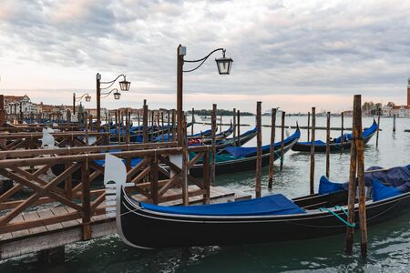 Gondolas anchored by Piazza San Marco with San Giorgio di Maggiore church in Venice, Italy,の写真素材