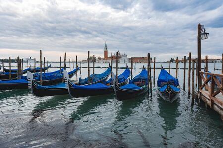 Gondolas anchored by Piazza San Marco with San Giorgio di Maggiore church in Venice, Italy,の写真素材