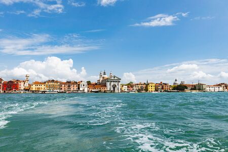 Venice. Vacation in Italy. Panoramic view of Venice from the Grand Canal. Venetian old colorful buildings on blue sky background. Boat trip through the canals. 

の写真素材